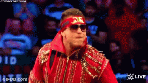 Wrestler In Sunglasses And Headband Walking On Stage GIF