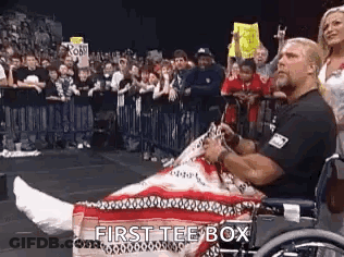 Wrestler In Wheelchair With Cast On Leg In Front Of Crowd GIF
