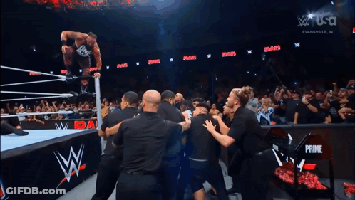 Wrestler Jumping In Air As Crowd Watches GIF