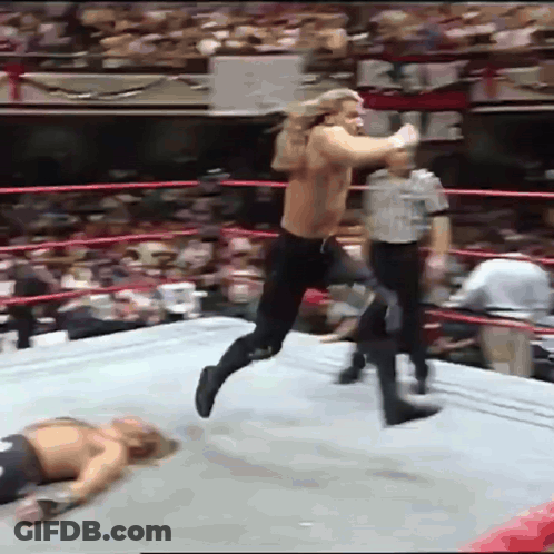 Wrestler Jumping Over Another On Ground GIF