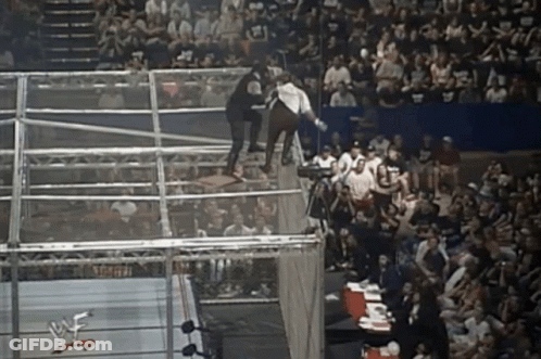 Wrestler Jumping Over Fence In Wrestling Ring GIF