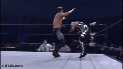 Wrestler Kicking Another In AEW Ring GIF
