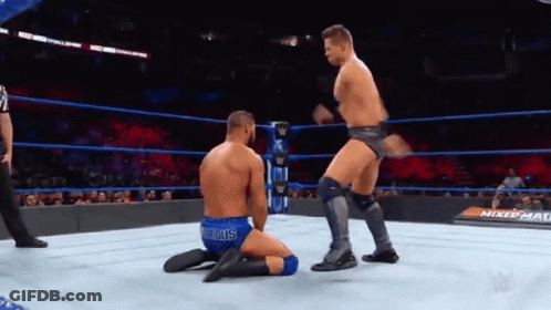 Wrestler Kneeling As Another Jumps In Ring GIF