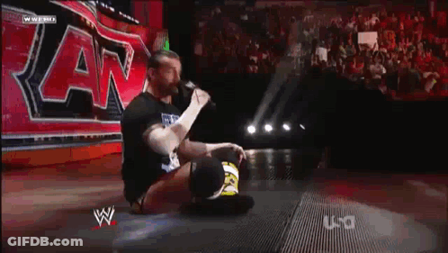 Wrestler Kneeling In Front Of Sign GIF