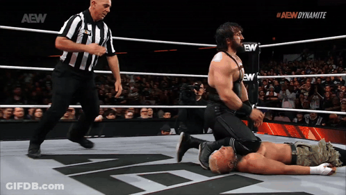 Wrestler Kneeling In Ring With AEW Dynamite Logo GIF