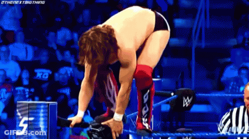 Wrestler Kneeling In Ring With Referee GIF