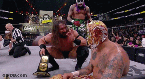 Wrestler Kneeling Next To Another In AEW Ring GIF