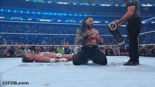 Wrestler Kneeling Over Opponent GIF