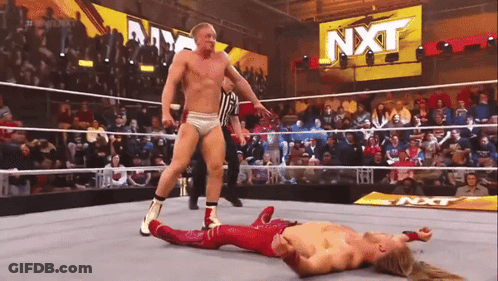 Wrestler Laying In Ring With NXT Sign GIF