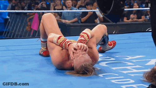 Wrestler Laying On Floor With Academy Text GIF