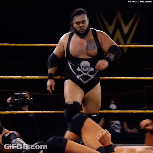 Wrestler Laying On Ground With Opponent Standing Over Him GIF