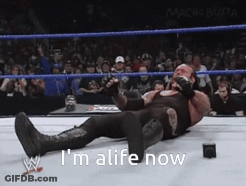 Wrestler Lying Down Saying Im Alive GIF