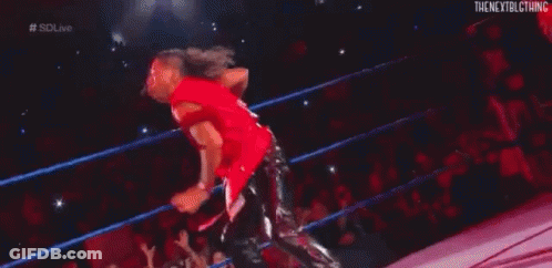 Wrestler Lying In Wrestling Ring With Hand Up GIF