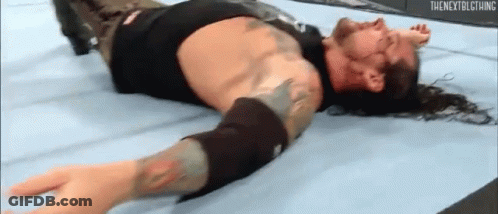 Wrestler Lying On Floor In Wrestling Ring GIF