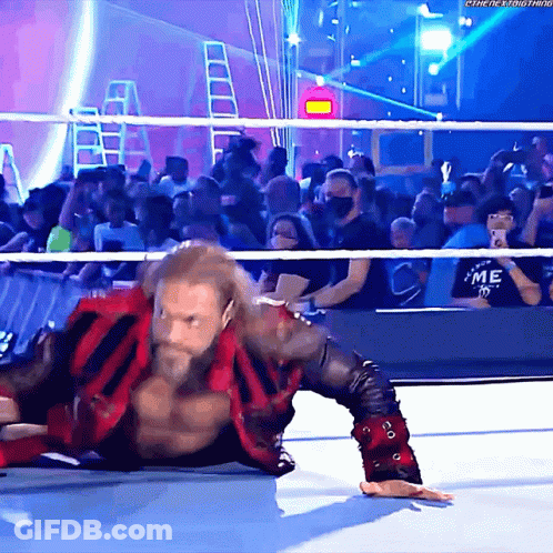 Wrestler Lying On Ground Before Crowd GIF