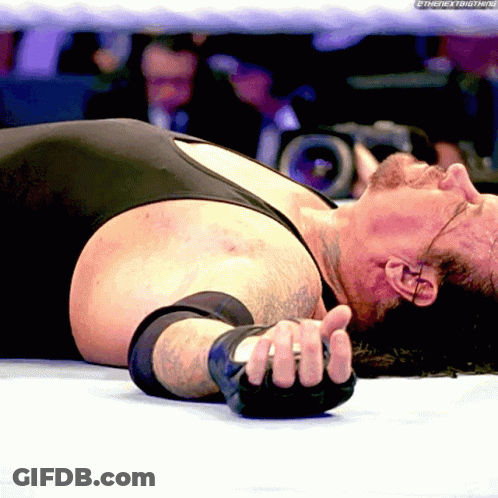Wrestler Lying On Ground With Hand On Face GIF
