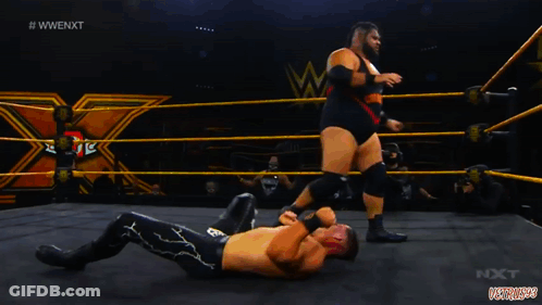 Wrestler Lying On Ground With Referee Behind GIF