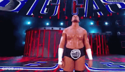 Wrestler On Stage With Sign Saying Big Chas GIF