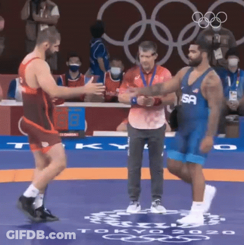 Wrestler Shaking Hands On Mat GIF