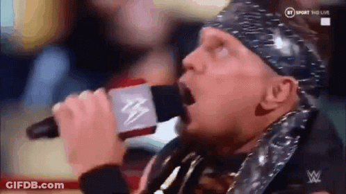 Wrestler Singing Into Microphone With Bandana GIF