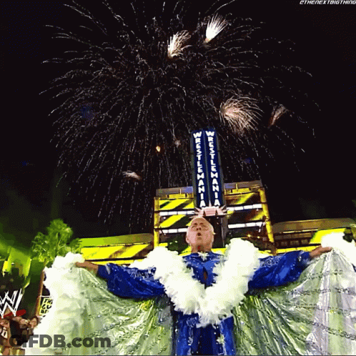 Wrestler Standing Before Wrestlemania Sign GIF