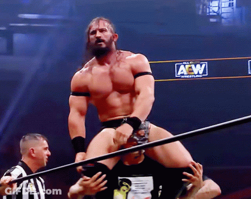 Wrestler Standing In Front Of AEW Sign GIF