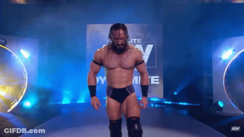 Wrestler Standing In Front Of Elite Sign GIF