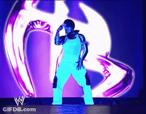 Wrestler Standing In Front Of Purple Logo GIF
