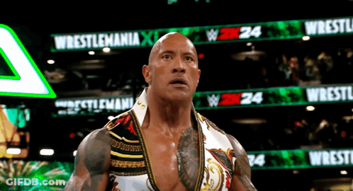 Wrestler Standing In Front Of Wrestlemania Sign GIF
