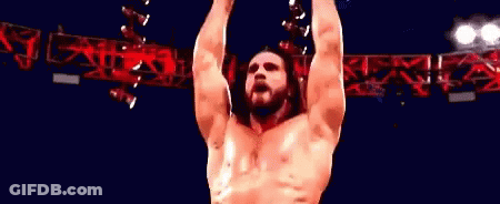 Wrestler Standing In Front Of Wrestling Sign GIF