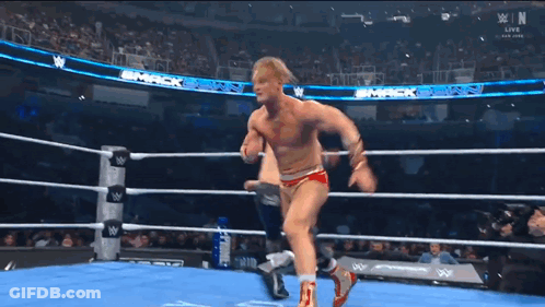 Wrestler Standing In Wrestling Ring With Another Wrestler GIF