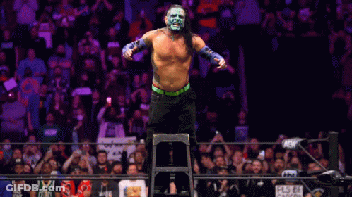 Wrestler Standing On Ladder In Front Of Crowd GIF