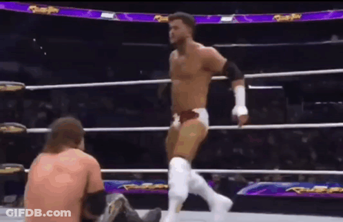 Wrestler Standing Over Seated Wrestler GIF