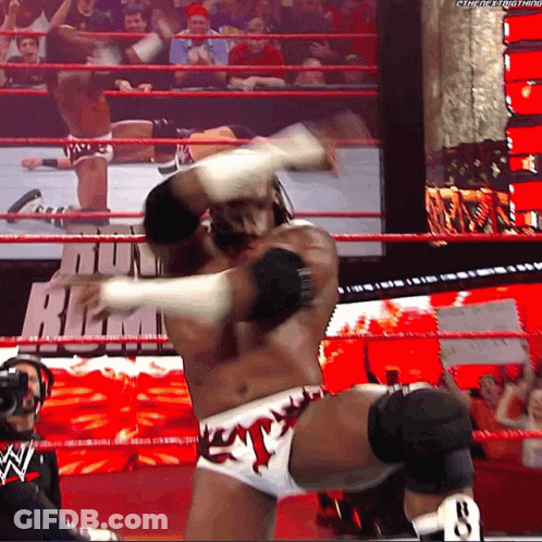 Wrestler Talking Into Microphone While Another Watches GIF
