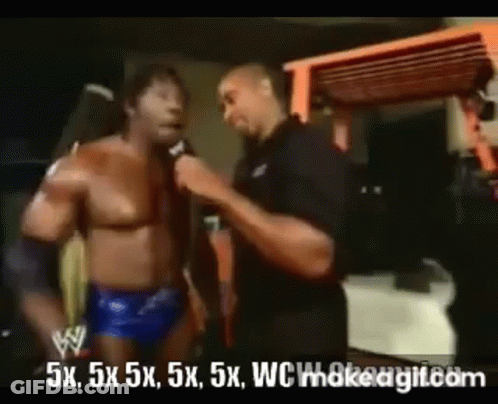 Wrestler Talking Into Microphone While Another Watches GIF