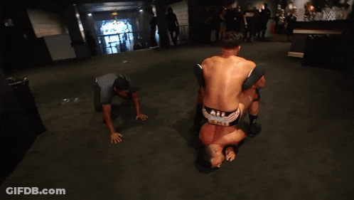 Wrestler Wearing Red And Black Knee Pads GIF