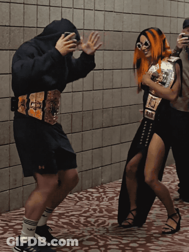 Wrestler With AEW Belt Next To Another Wrestler GIF