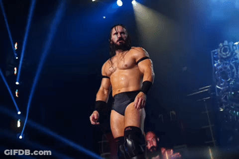 Wrestler With Beard Standing On Stage With Letter M GIF