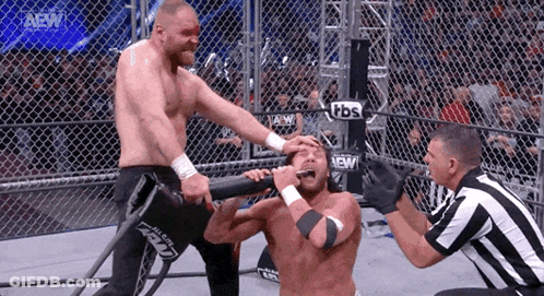 Wrestler With Forehead Bandage Attacked In Cage GIF