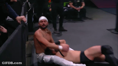 Wrestler With Head Bandage Lying With Another GIF