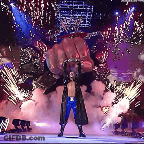 Wrestler With Letter R On Belt In Front Of Giant Hand GIF
