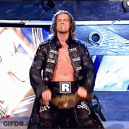 Wrestler With Letter R On Belt On Stage GIF