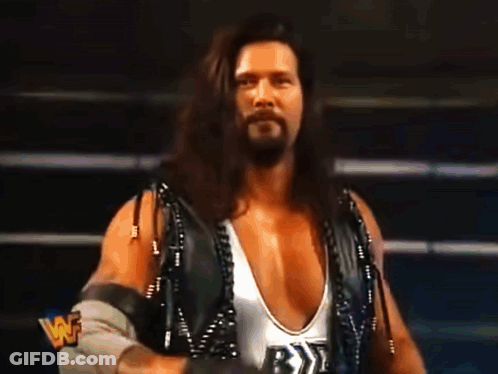 Wrestler With Long Hair And Beard In White Tank Top With Letter B GIF