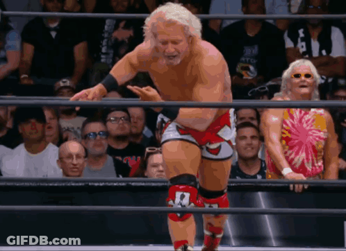 Wrestler With Number 1 On Knee In Ring GIF