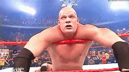 Wrestler With Red Mask And Black Gloves Phoning GIF