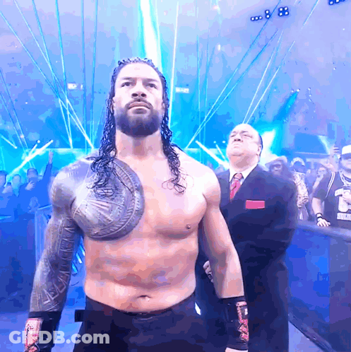 Wrestler With Shield In Front Of Crowd And Referee GIF
