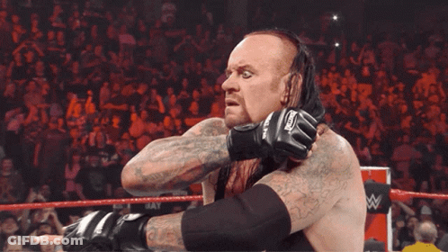 Wrestler With Undertaker Gloves Tongue Out GIF