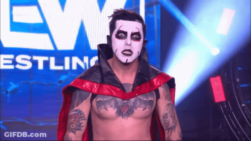 Wrestler With White Face And Red Cape GIF