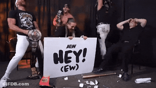 Wrestlers Holding Sign Saying Hey GIF