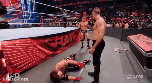 Wrestlers In A Ring With A Banner That Says Raw GIF